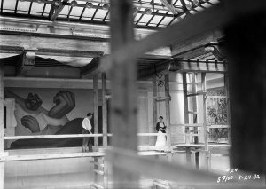 photographer unknown - Diego Rivera and Frida Kahlo on scaffolding in front of the work-in-progress Detroit Industry murals, DIA, 1932