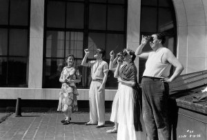 photographer unknown - Frida Kahlo and Diego Rivera, with colleagues, viewing a solar eclipse from the DIA roof, 1932