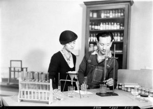 photographer unknown - Frida Kahlo looks on as Andres Sanchez Flores tests pigments for Diego Rivera's Detroit Industry murals at the DIA, 1933