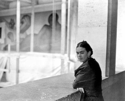 photographer unknown - Frida Kahlo on a balcony above the work-in-progress Detroit Industry murals at the DIA, 1932